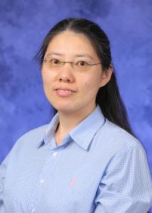 Headshot of Yang Yang, an Asian woman with long dark hair and glasses wearing a blue collared shirt.