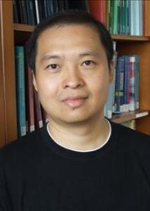 Headshot of Yunfeng Shit with short, cropped black hair and black shirt with white trimmed collar.